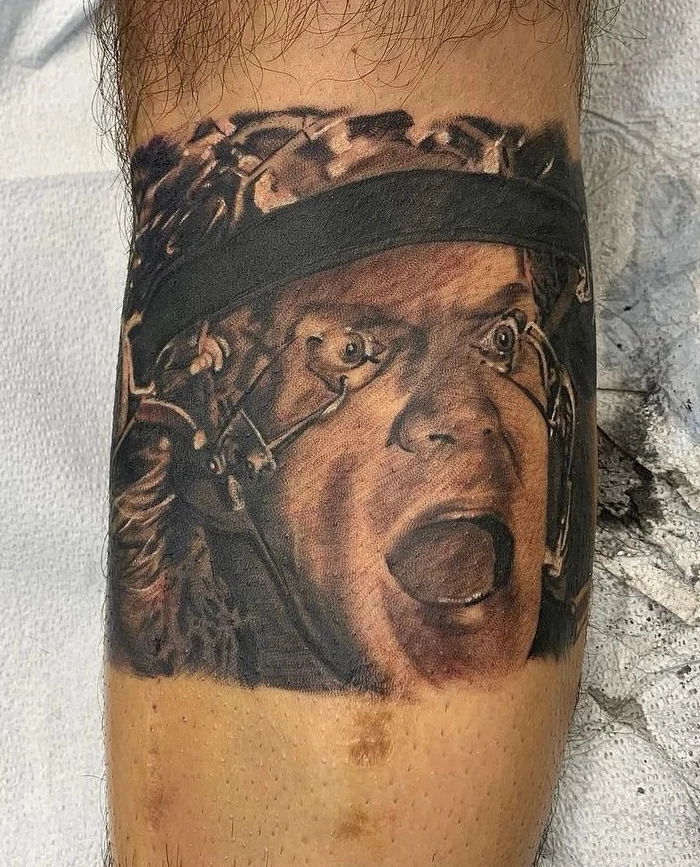 Clockwork orange eyes held open calf tattoo done in black and grey ink by tattoo artist Russ Howie of Sacred Mandala Studio in Durham, NC.